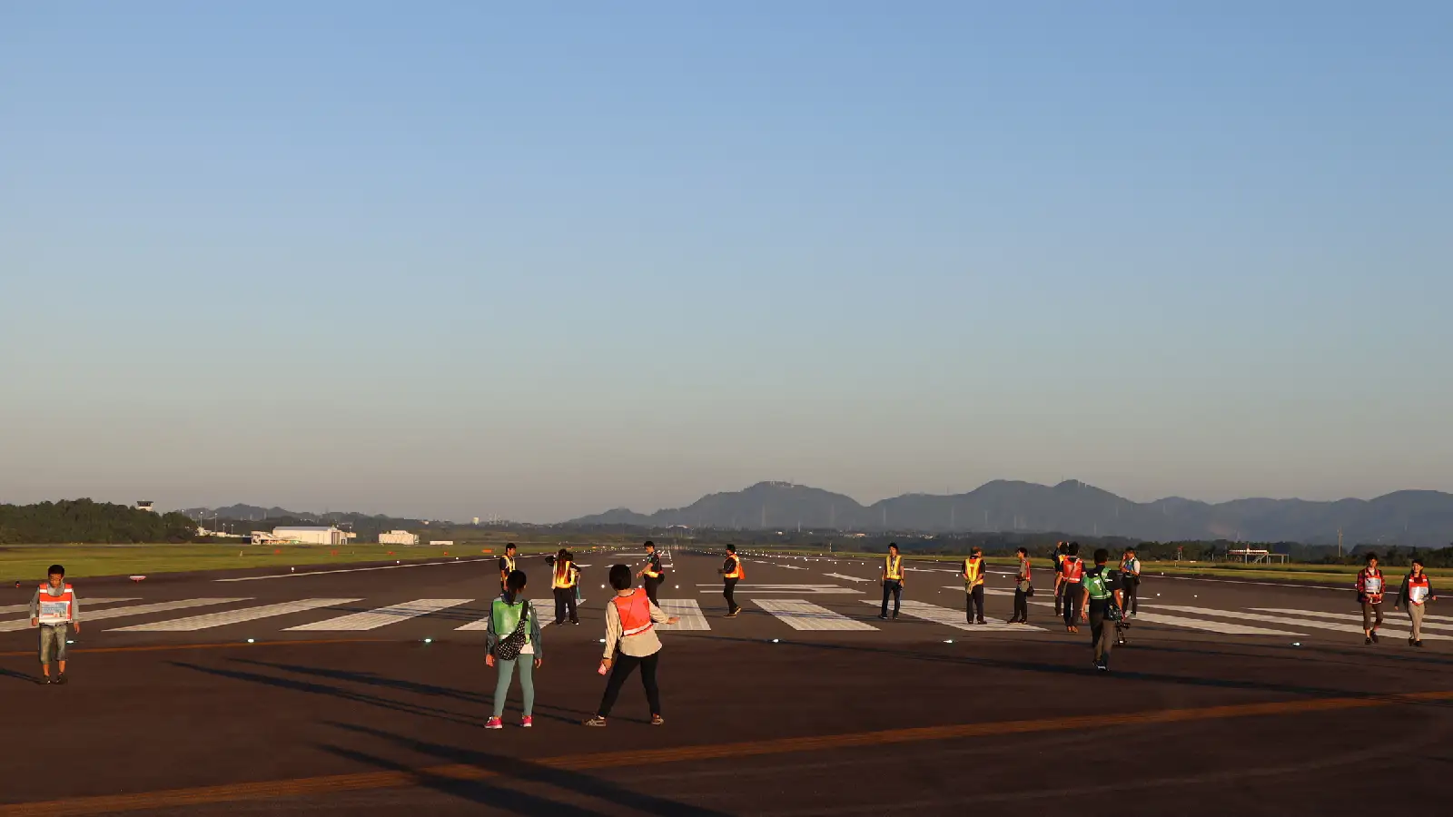 富士山静岡空港の滑走路をウォーキングするツアー参加者たち